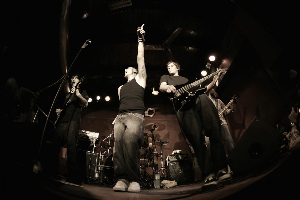 Band performing on stage, fisheye