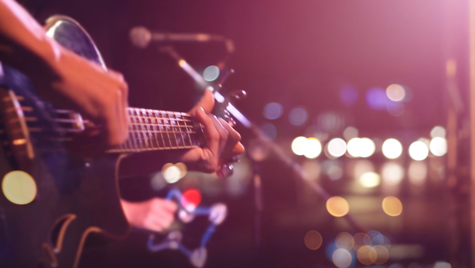 Guitarist on stage, softly blurred